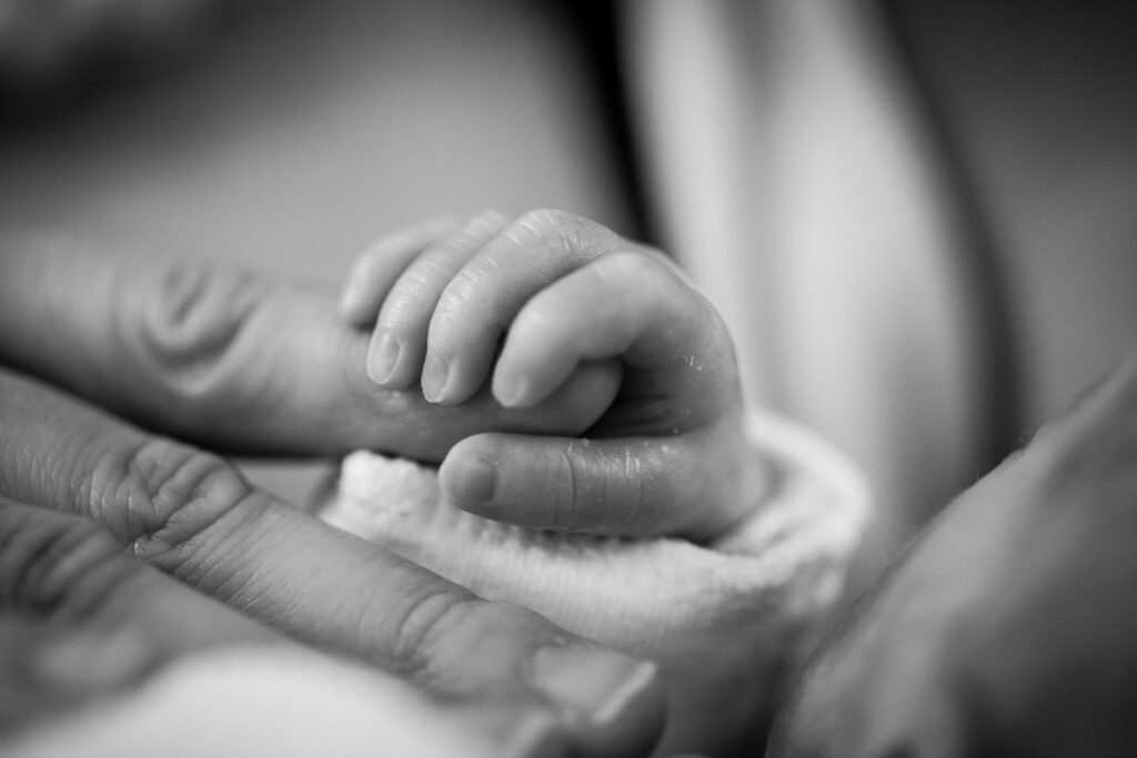 Baby grasping hand
